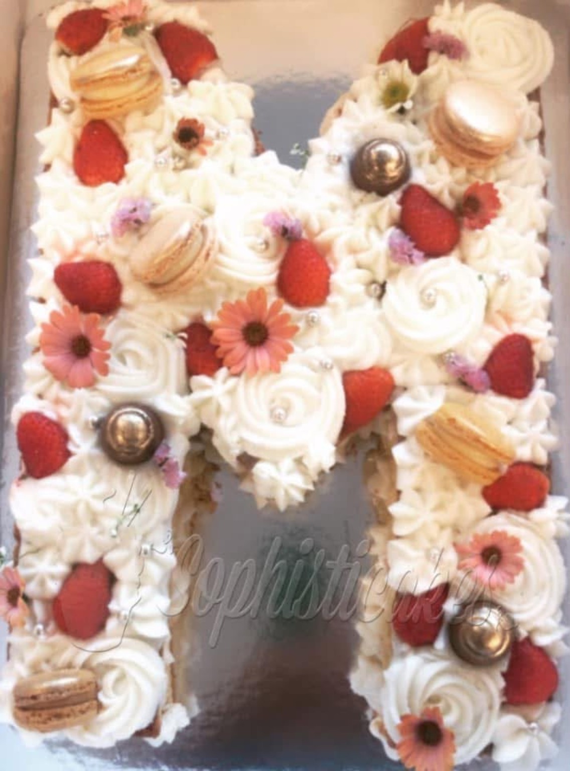 Queque elegante con perlas, detalles dorados y mariposas rosadas